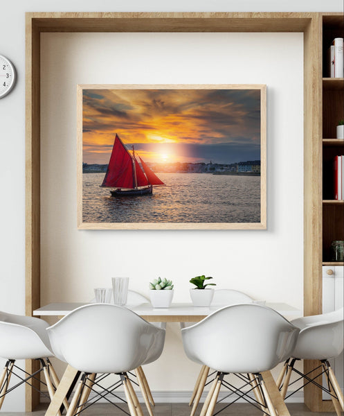 Colorful framed print depicting a traditional Galway Hooker boat sailing on serene waters, evoking maritime nostalgia.