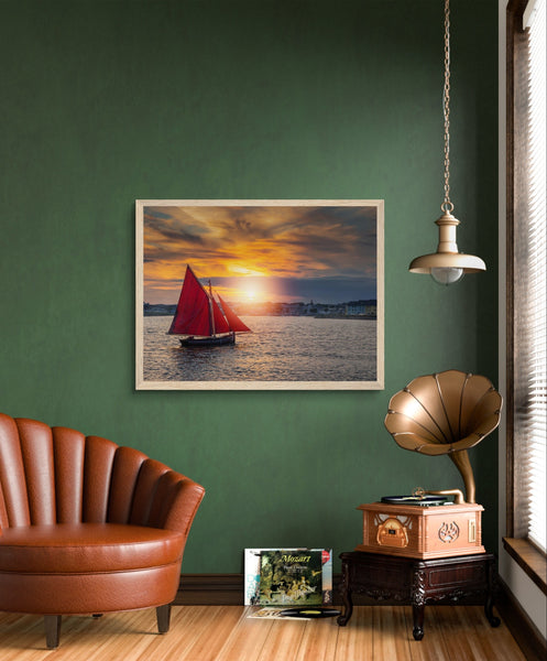 Vibrant framed print of a Galway Hooker sailing on the sea, capturing the rich maritime heritage of Ireland. Perfect for home or office decor.