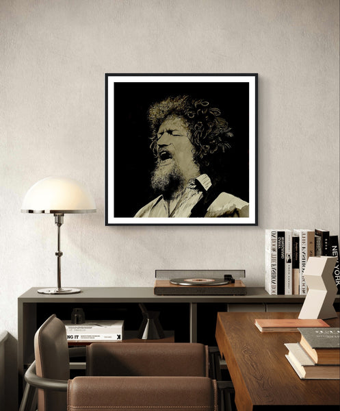 Framed art print of Luke Kelly by Irish artist Mullan. The piece captures Kelly singing On Raglan Road, showcasing his emotive expression. High-quality framing adds elegance, making it a perfect tribute to the legendary singer and a beautiful addition to any home.