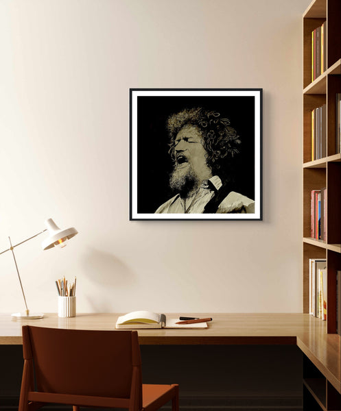 Framed art print of Luke Kelly by Irish artist Mullan. The piece captures Kelly singing On Raglan Road, showcasing his emotive expression. High-quality framing adds elegance, making it a perfect tribute to the legendary singer and a beautiful addition to any home.