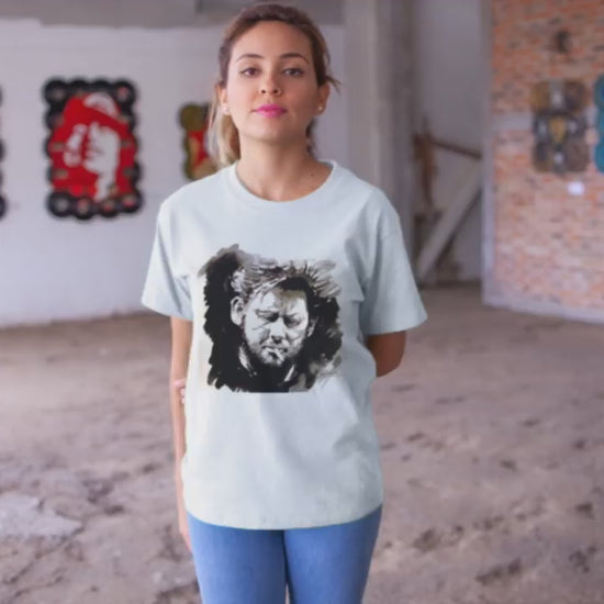 video of a girl wearing a Shane MacGowan T-Shirt featuring a bold portrait of the Irish folk music legend, capturing his iconic presence with a vintage vibe and rock and roll flair.