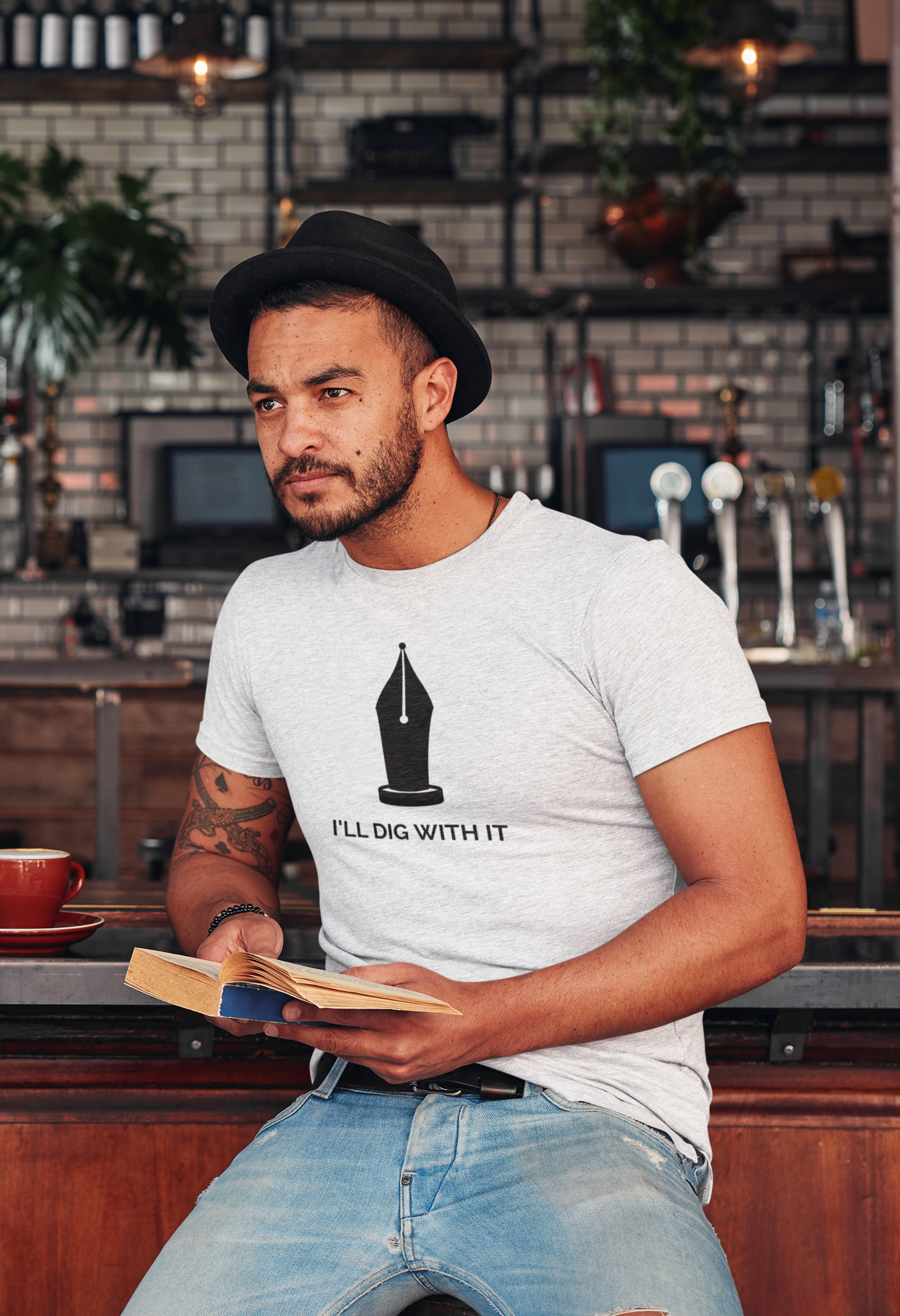 Seamus Heaney-inspired T-shirt with I'll Dig with it text. Made from premium cotton, featuring earthy colors and tasteful typography. Perfect for literature lovers and gardeners. Available in various sizes for a comfortable fit. A unique and thoughtful gift.