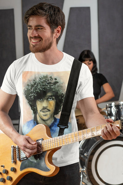 Phil Lynott tribute T-shirt: White, featuring iconic Thin Lizzy frontman graphic. Comfortable, durable fabric, perfect for rock music lovers and fans. Ideal gift or unique wardrobe addition. Celebrate Irish rock heritage and Phil Lynott's legendary style.